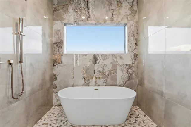 a bathroom with a bathtub and shower