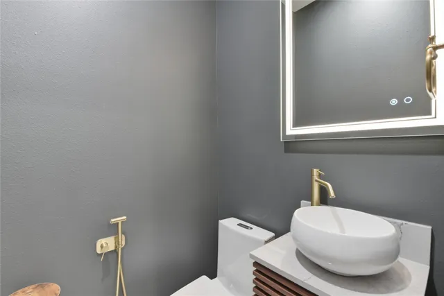 a bathroom with a toilet a sink and mirror