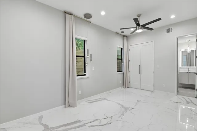 a view of a livingroom with a ceiling fan and entryway