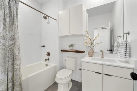 a bathroom with a sink toilet and shower