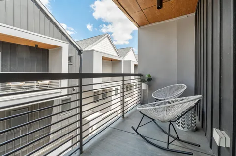 a view of a chairs and tables in the balcony