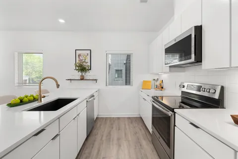 a kitchen with a sink stove and microwave