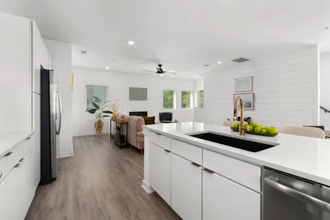 a kitchen with sink refrigerator and window