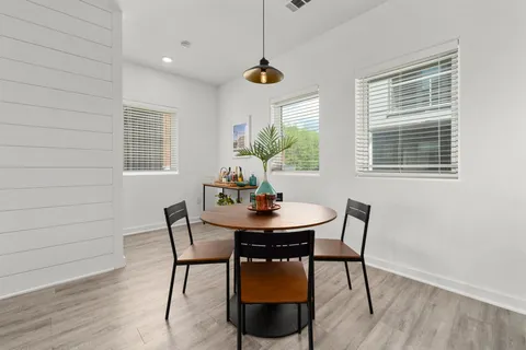 a dining room with furniture and window