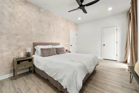 a bedroom with a bed and a ceiling fan