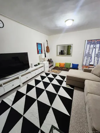 a living room with a black white checkered floor with black white checkered floor