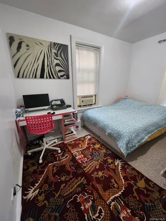 a bedroom with bed and a window