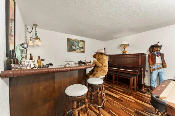 a living room with furniture a piano and a fireplace