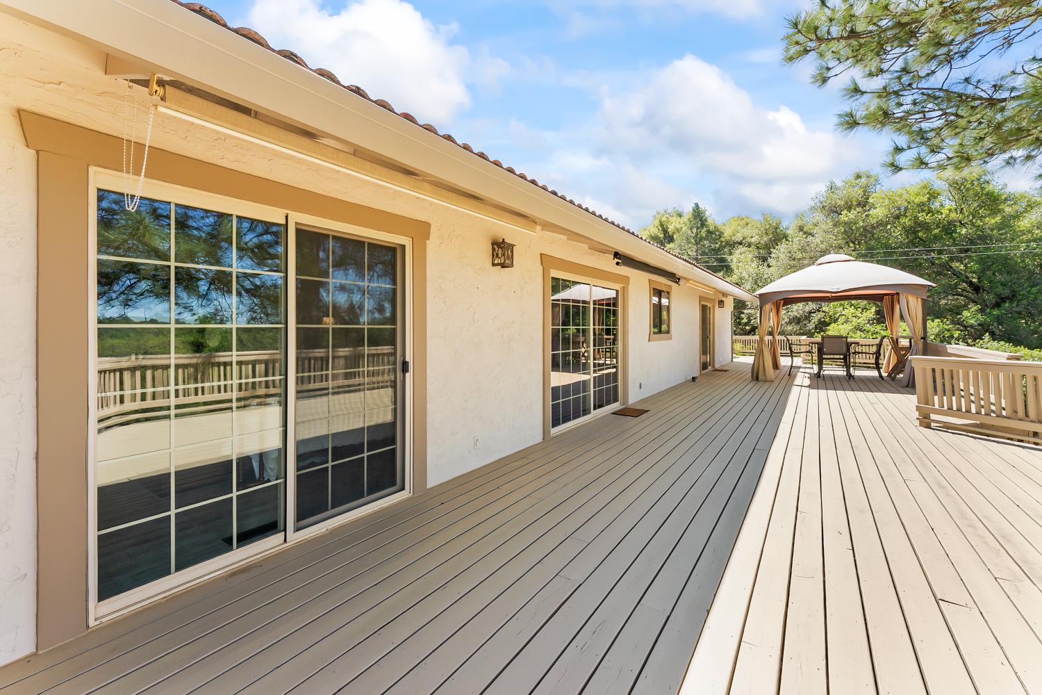 17065 Niles Road Jackson, CA 95642 - Photo 19 of 23 a view of a house with a barbeque and wooden floor