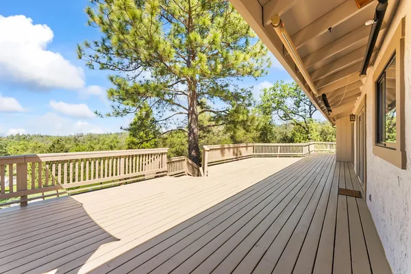 a view of balcony with wooden floor and fence