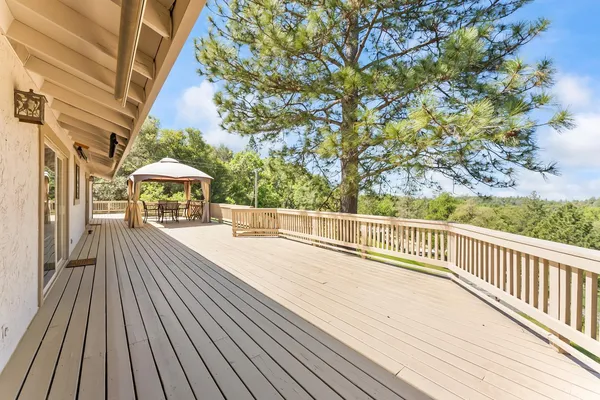 a view of a house with wooden deck