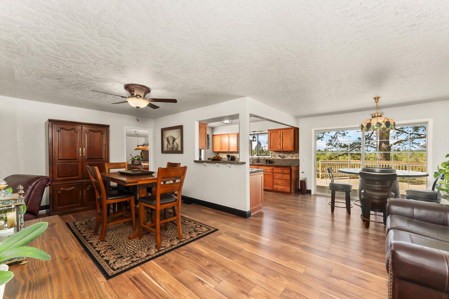 17065 Niles Road Jackson, CA 95642 - Photo 8 of 23 a living room with furniture a dining table and chairs with wooden floor