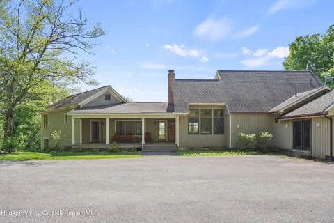 front view of a house next to a yard