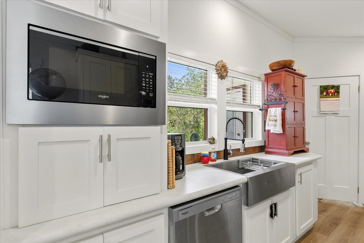 1705 Makinson Road West Point, TX 78963 - Photo 6 of 40 White cabinetry and appliances create a bright and airy kitchen space with ample natural illumination.