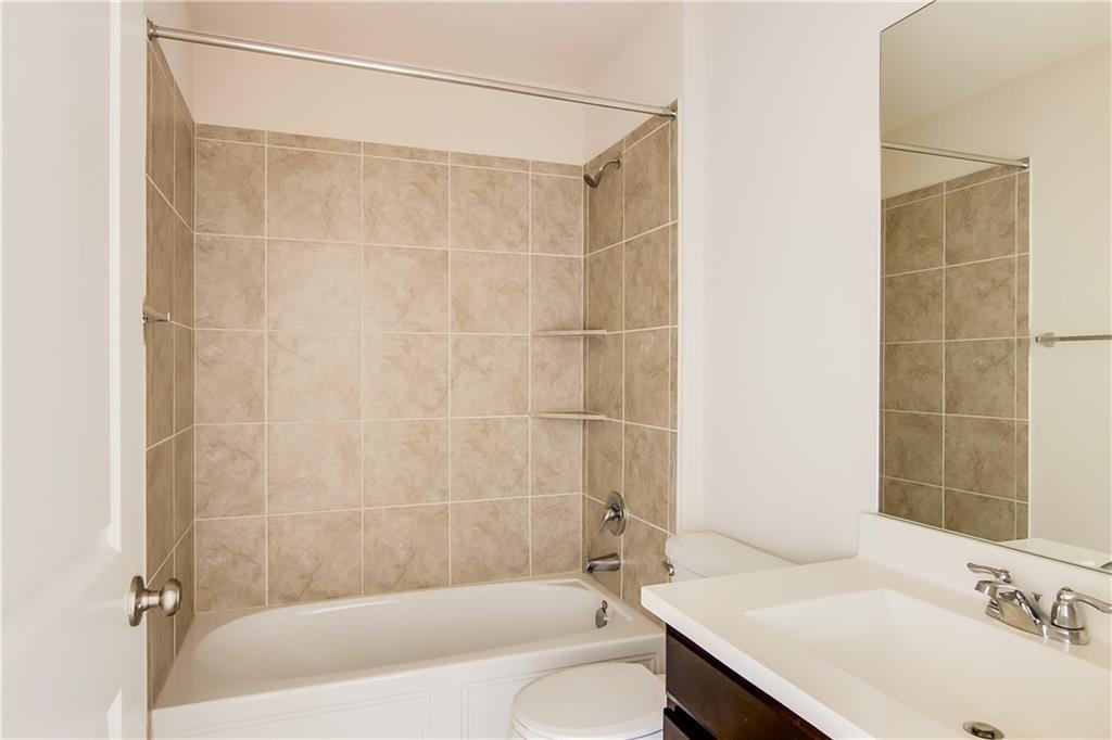 5916 Kennedy Street Austin, TX 78747 - Photo 15 of 25 Bathroom with vanity and washtub / shower combination