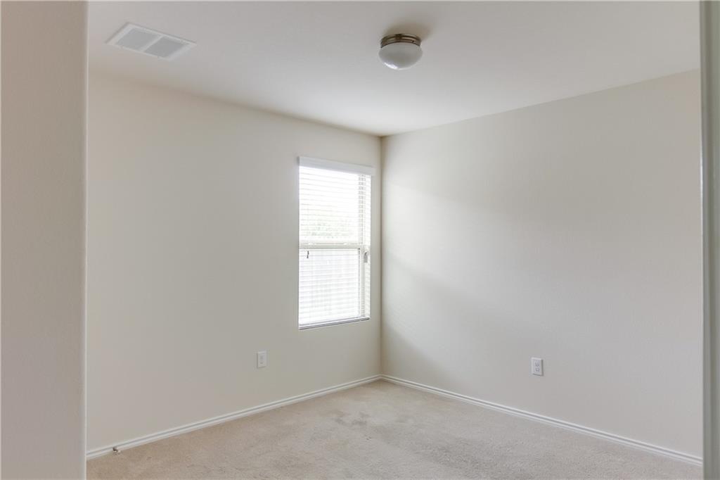 5916 Kennedy Street Austin, TX 78747 - Photo 16 of 25 Spare room with light colored carpet and baseboards