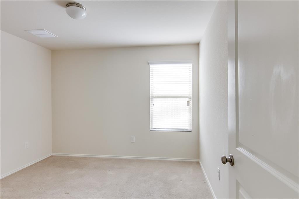5916 Kennedy Street Austin, TX 78747 - Photo 17 of 25 Unfurnished room with light colored carpet and baseboards