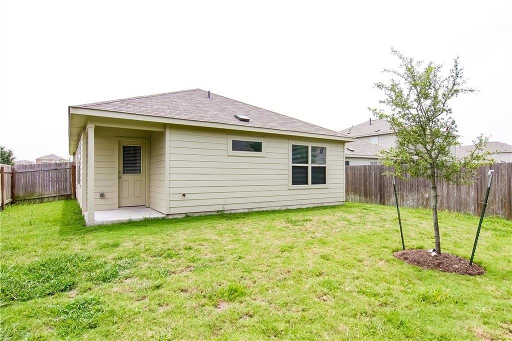 5916 Kennedy Street Austin, TX 78747 - Photo 19 of 25 Rear view of house with a patio, a fenced backyard, and roof with shingles