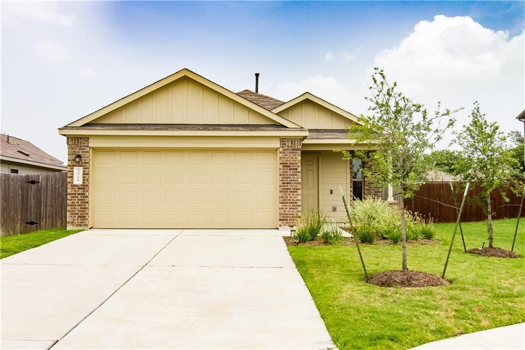 5916 Kennedy Street Austin, TX 78747 - Photo 23 of 25 View of front of house with brick siding, an attached garage, board and batten siding, and concrete driveway