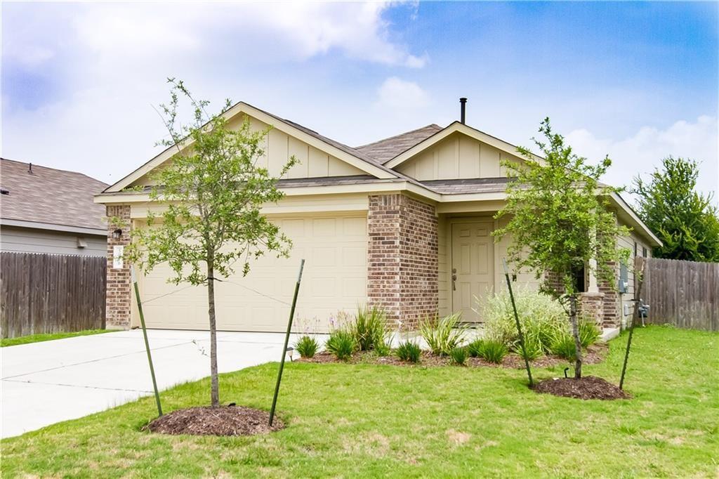 5916 Kennedy Street Austin, TX 78747 - Photo 24 of 25 View of front of property featuring board and batten siding, driveway, a garage, brick siding, and a shingled roof