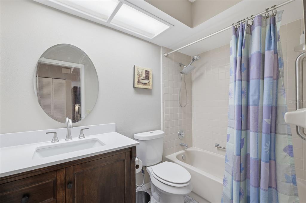 11541 Orleans Lane Port Richey, FL 34668 - Photo 19 of 53 a bathroom with a granite countertop toilet sink and shower