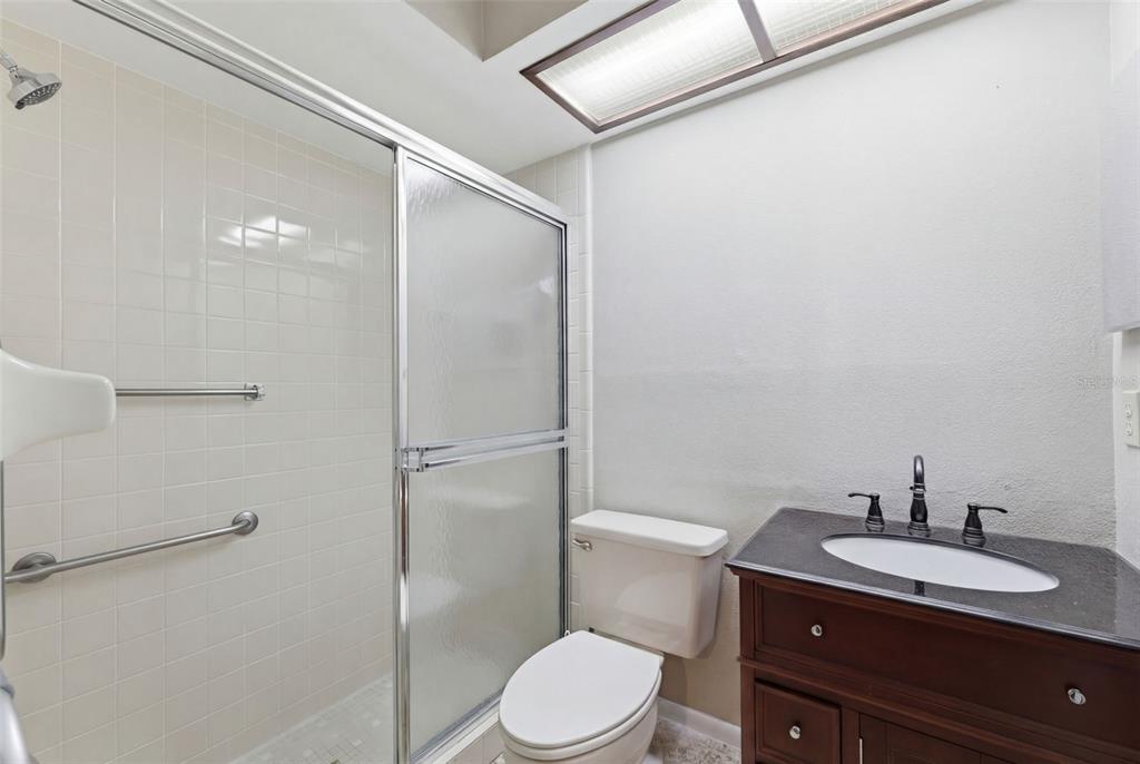 11541 Orleans Lane Port Richey, FL 34668 - Photo 22 of 53 a bathroom with a granite countertop sink toilet and shower