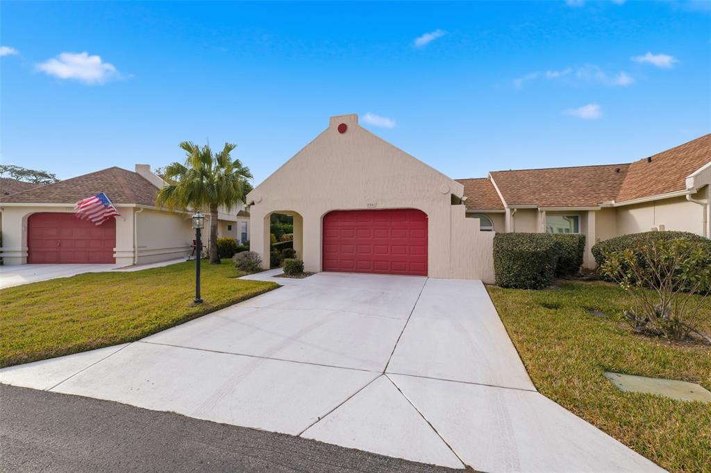 11541 Orleans Lane Port Richey, FL 34668 - Photo 5 of 53 a view of a house with a yard and garage
