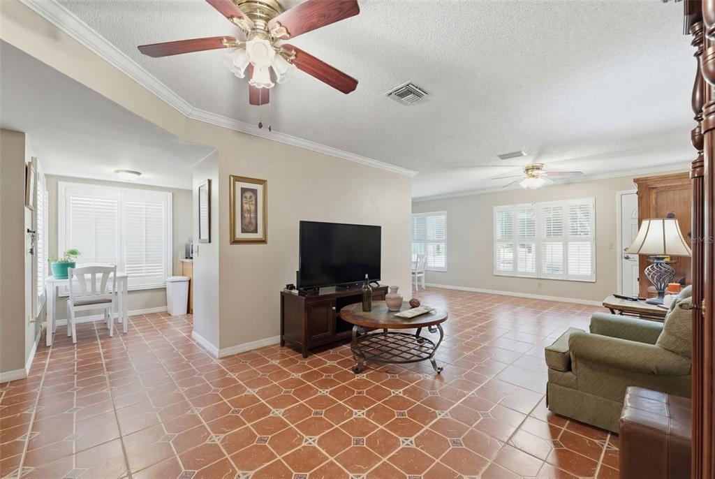 11541 Orleans Lane Port Richey, FL 34668 - Photo 9 of 53 a living room with furniture a flat screen tv and a window