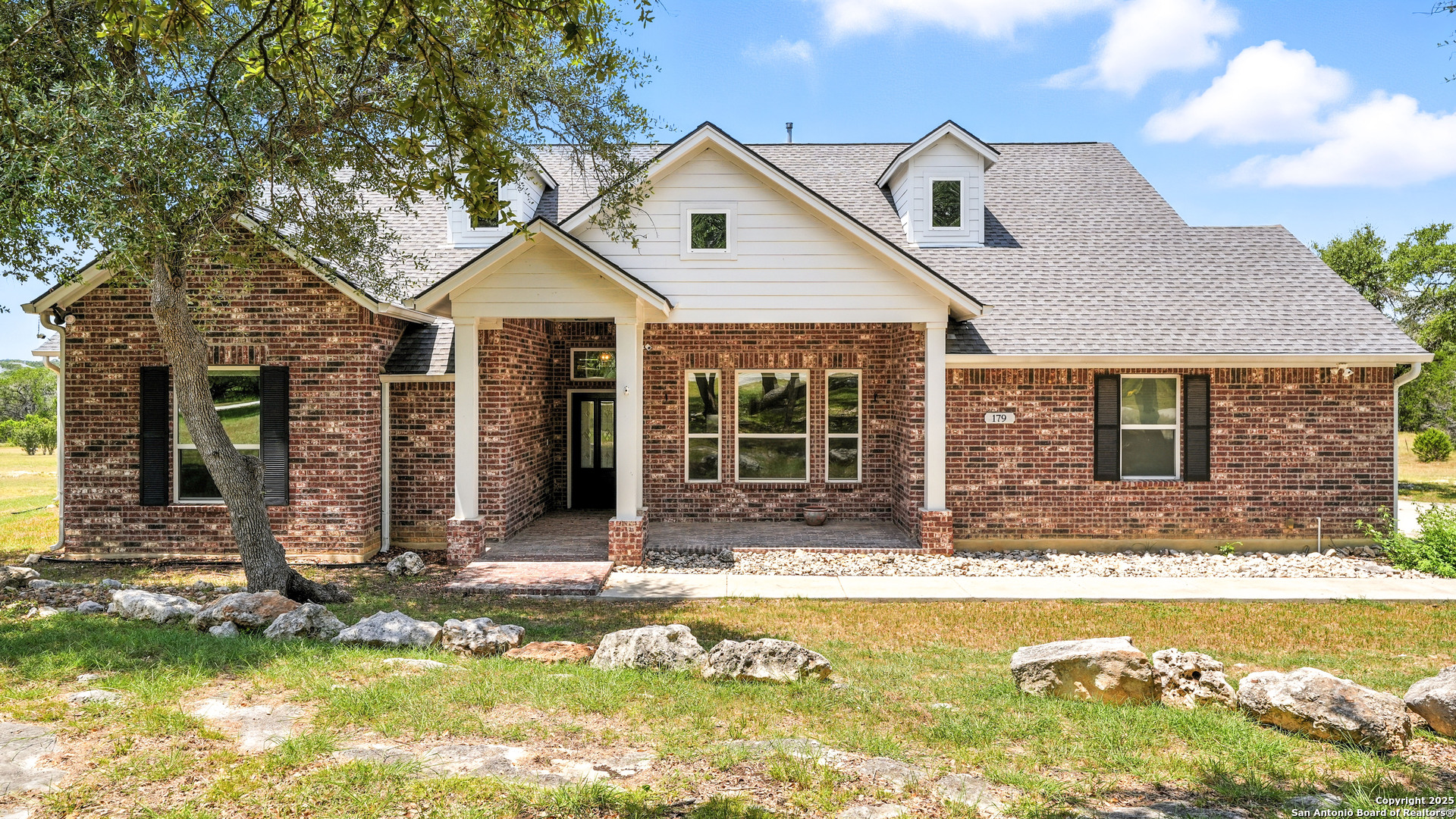 179 Prairie Dawn Spring Branch, TX 78070 - Photo 2 of 45 a front view of a house with a yard outdoor seating and yard in front of it