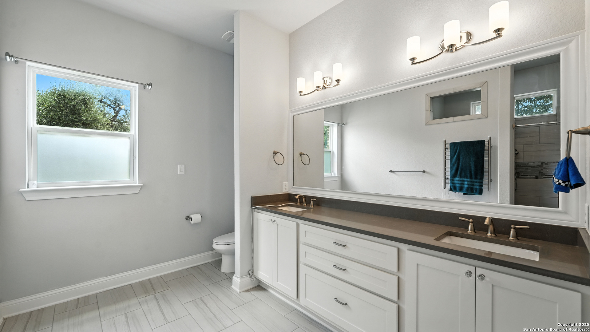 179 Prairie Dawn Spring Branch, TX 78070 - Photo 25 of 45 a bath room with a sink and a large mirror