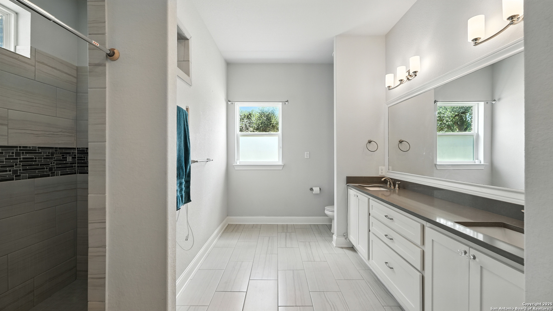 179 Prairie Dawn Spring Branch, TX 78070 - Photo 26 of 45 a spacious bathroom with a granite countertop sink a mirror and a bathtub
