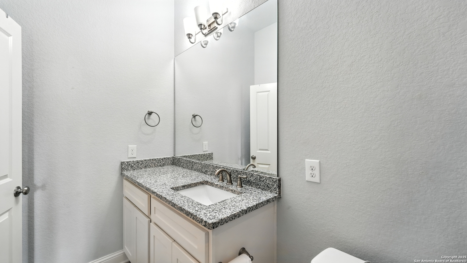 179 Prairie Dawn Spring Branch, TX 78070 - Photo 29 of 45 a bathroom with a granite countertop sink and a mirror