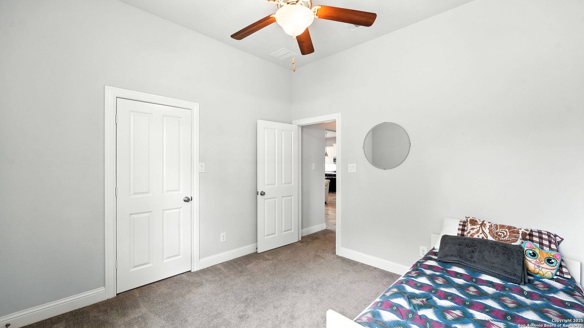 179 Prairie Dawn Spring Branch, TX 78070 - Photo 32 of 45 a bedroom with a bed and a chandelier