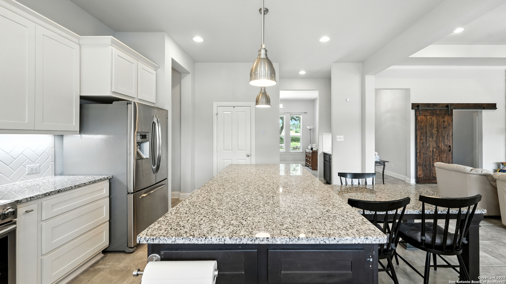 179 Prairie Dawn Spring Branch, TX 78070 - Photo 5 of 45 a kitchen with a table and refrigerator
