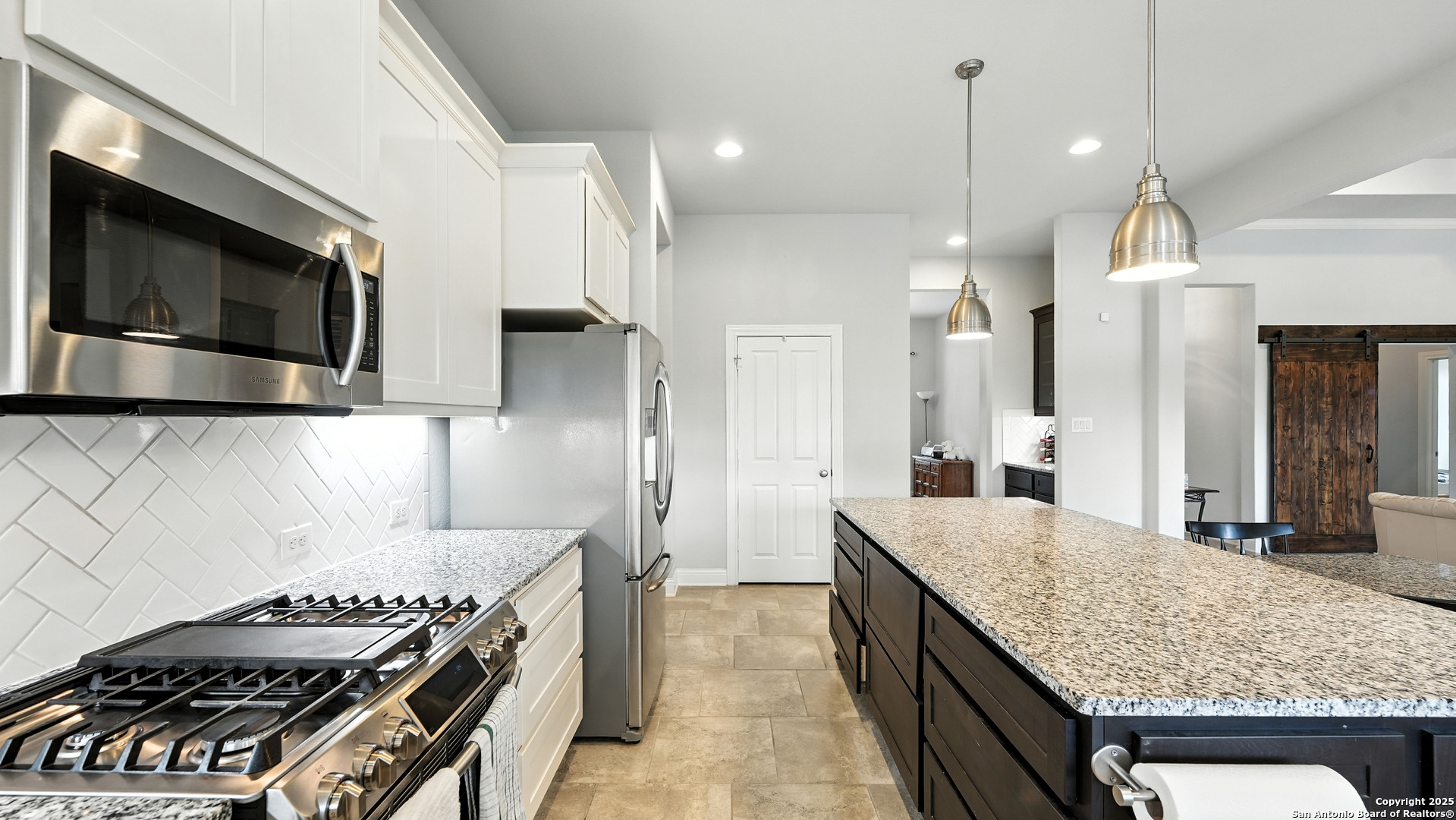 179 Prairie Dawn Spring Branch, TX 78070 - Photo 7 of 45 a kitchen with stainless steel appliances granite countertop a stove and a sink
