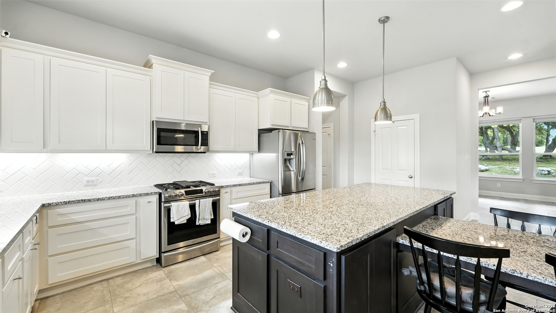 179 Prairie Dawn Spring Branch, TX 78070 - Photo 9 of 45 a kitchen with a stove kitchen island and stainless steel appliances