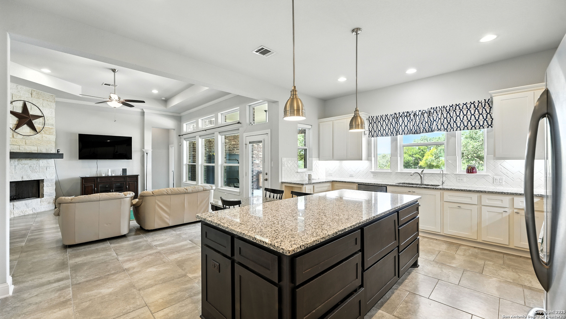 179 Prairie Dawn Spring Branch, TX 78070 - Photo 10 of 45 a kitchen with granite countertop a sink and white cabinets