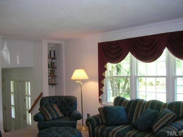 533 Maple Lane Raleigh, NC 27603 - Photo 8 of 25 a living room with furniture and a large window