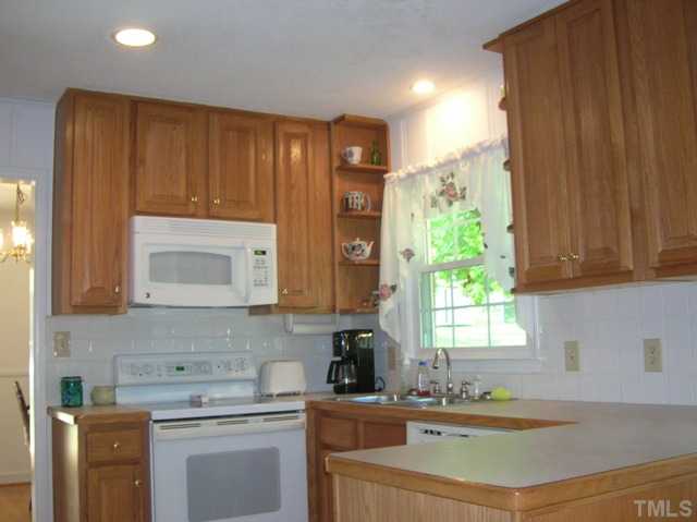 533 Maple Lane Raleigh, NC 27603 - Photo 10 of 25 a kitchen with a sink cabinets and window