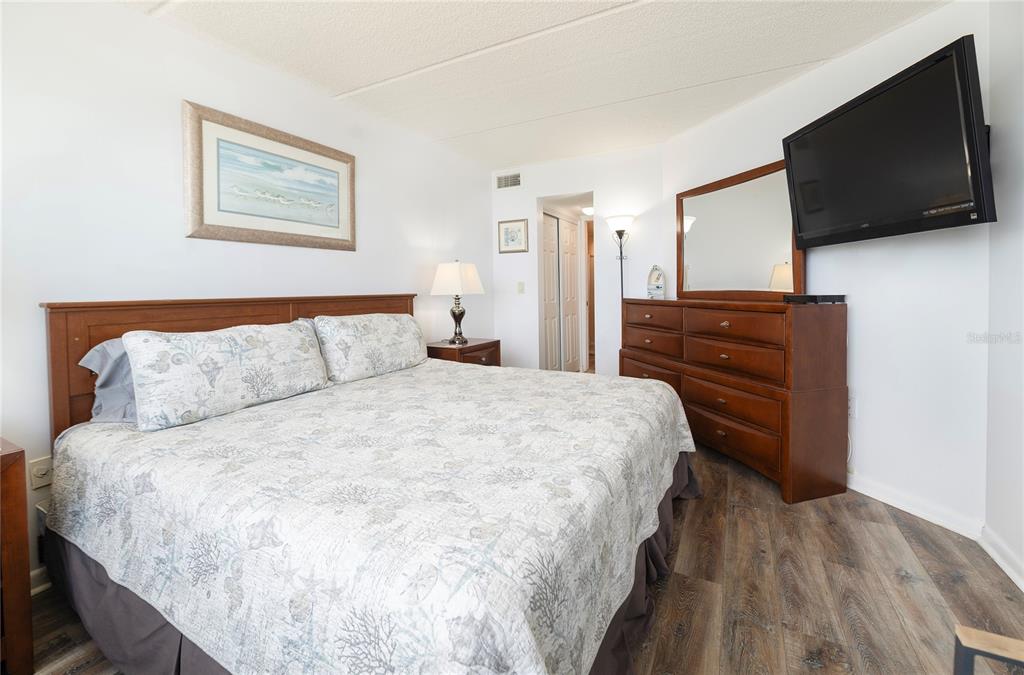4453 South Atlantic Avenue, Unit 604 Ponce Inlet, FL 32127 - Photo 13 of 28 a bedroom with a bed and a flat screen tv