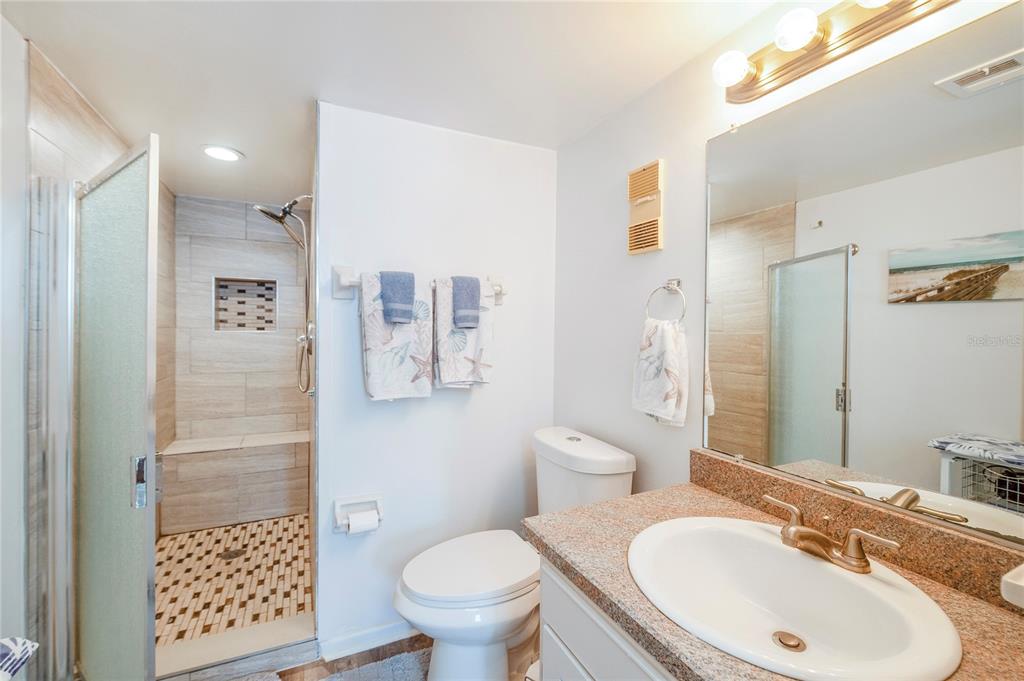 4453 South Atlantic Avenue, Unit 604 Ponce Inlet, FL 32127 - Photo 16 of 28 a bathroom with a sink toilet and shower