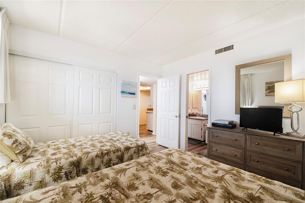 4453 South Atlantic Avenue, Unit 604 Ponce Inlet, FL 32127 - Photo 18 of 28 a bedroom with a bed and a flat screen tv