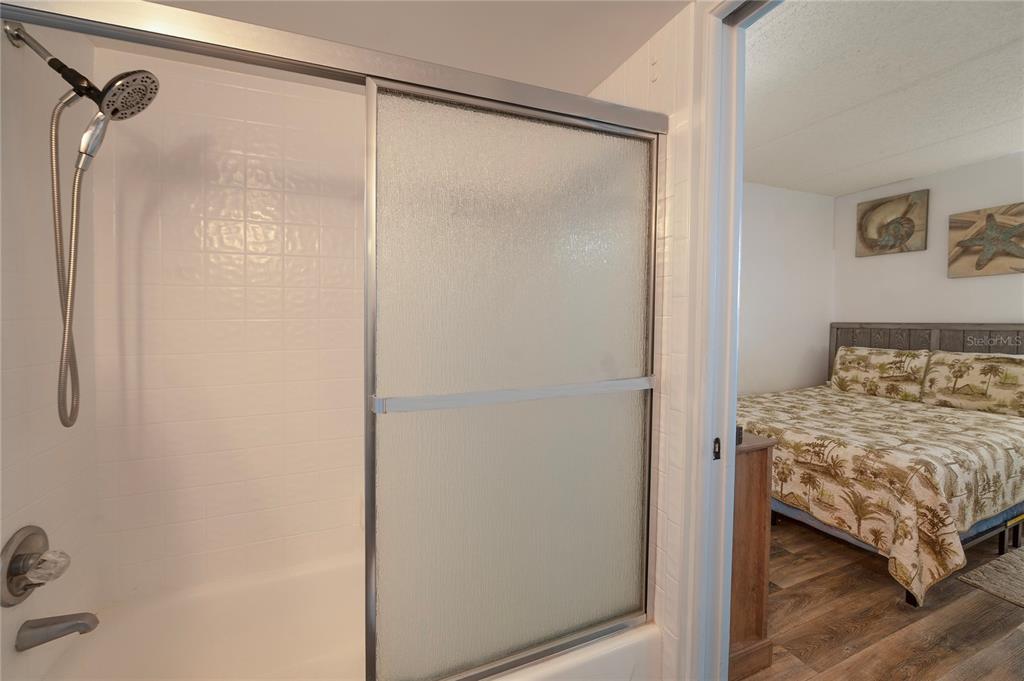 4453 South Atlantic Avenue, Unit 604 Ponce Inlet, FL 32127 - Photo 19 of 28 a bedroom with a bed and a mirror