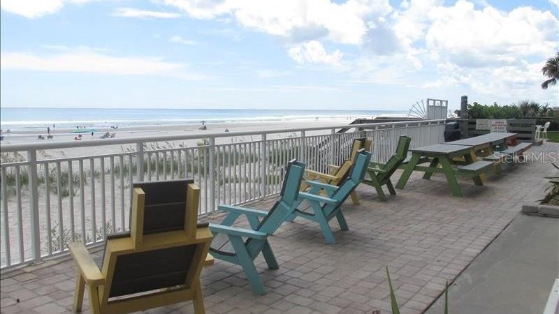 4453 South Atlantic Avenue, Unit 604 Ponce Inlet, FL 32127 - Photo 27 of 28 a view of a chair and table on the terrace