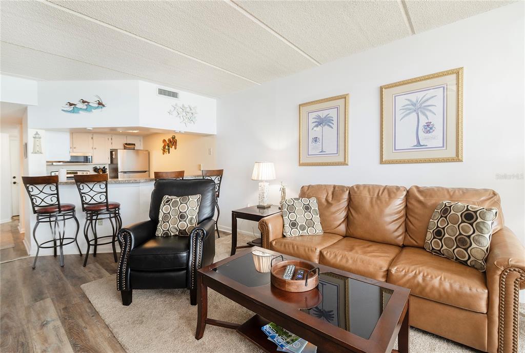 4453 South Atlantic Avenue, Unit 604 Ponce Inlet, FL 32127 - Photo 9 of 28 a living room with furniture and wooden floor