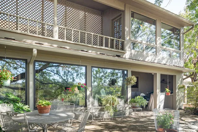 a view of a house with a porch and furniture