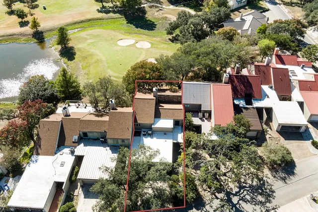 an aerial view of a house with a yard pool patio and lake view
