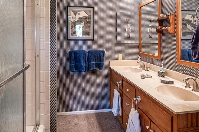 a bathroom with a sink double vanity and a mirror