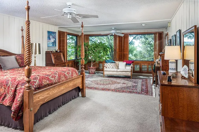 a bedroom with a large bed and a chandelier