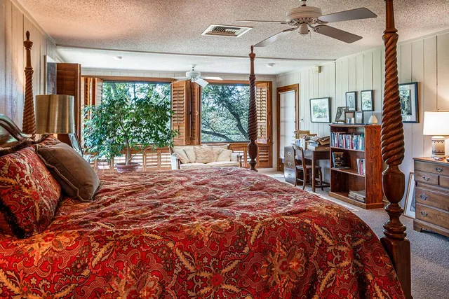 a bed sitting in a bedroom next to a window